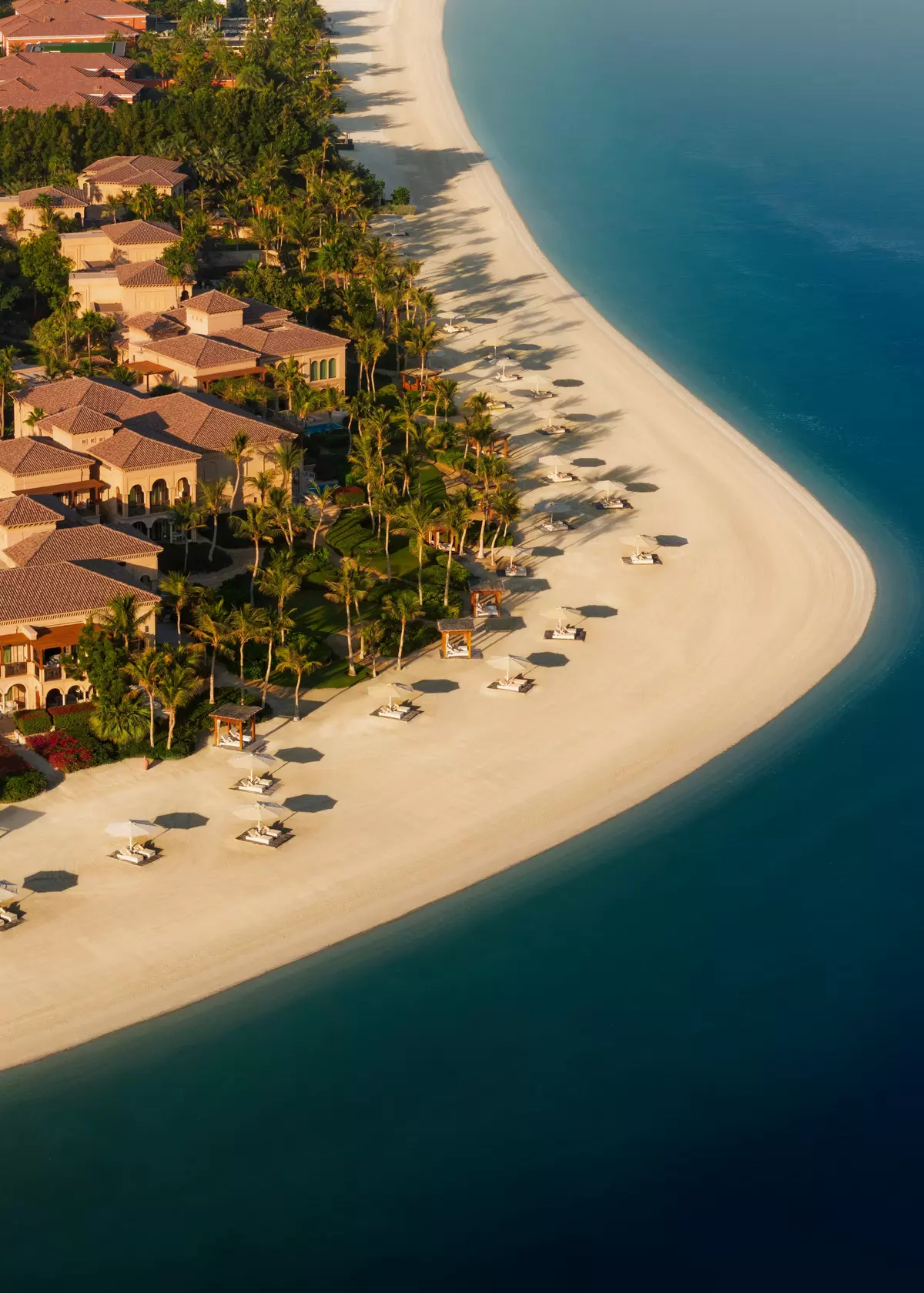 Aerial view of One&Only The Palm resort beach at golden hour